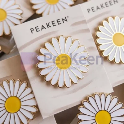 Custom white and yellow daisy pin displayed on a card, showcasing its vibrant colors and intricate design.