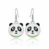 Panda bear earrings featuring green eyes and a white face, alongside playful dog earrings in a colorful display.