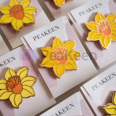 Custom daffodil enamel pin featuring a vibrant yellow flower design, perfect for adding a touch of spring to any outfit.