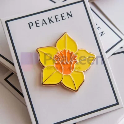 Custom daffodil enamel pin featuring a vibrant yellow flower design, perfect for adding a touch of spring to any outfit.