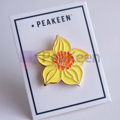 Custom daffodil enamel pin featuring a vibrant yellow flower design, perfect for adding a touch of spring to any outfit.