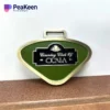 Porte-clés en métal vert et doré à l'effigie de "Beauty World of Ocala", conçu comme une étiquette de sac de golf.