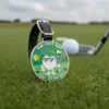 A golf ball on the green with a golf bag tag, showcasing a second golf ball nearby.