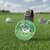 A golf ball featuring a smaller golf ball design, placed on the ground among golf bag tags.