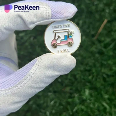 A person holds a golf ball marker featuring a car design, showcasing a unique accessory for golf enthusiasts.