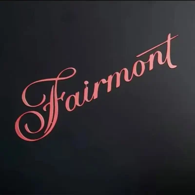 Red "Fairmont" text on a black background, displayed as a metal sticker, emphasizing a bold and modern design.