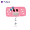 A pink nurse badge reel featuring a cute face design, perfect for adding charm to your work attire.