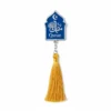 Blue and yellow tassel bookmark featuring the word "Quran" prominently displayed.