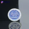 A blue and white lapel pin featuring the word "Recovery," symbolizing support from Alcoholics Anonymous.