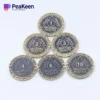 A collection of six bronze coins featuring the word "monthly," symbolizing milestones in Alcoholics Anonymous.