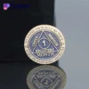 A gold and blue lapel pin featuring the words "1 month," symbolizing sobriety in Alcoholics Anonymous.