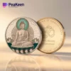 Buddha coin displayed with the inscription "peeken" clearly visible on its face.