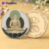 A serene Buddha coin positioned atop a colorful flower, representing harmony and spiritual beauty.