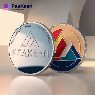 Logo of Peakeen displayed prominently on a corporate challenge coin, symbolizing achievement and recognition.