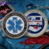 A medical badge alongside a card featuring an ambulance, representing an EMS challenge coin.