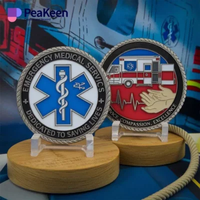 Two EMS challenge coins displayed on a wooden stand, showcasing their intricate designs and significance in emergency services.