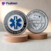 Two silver and one bronze medallion featuring "Emergency Medical Services" text, representing EMS challenge coins.