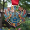 Colorful fiesta medal featuring a guitar surrounded by decorative birds, celebrating cultural festivities.