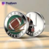 A football flipping coin displaying the words "heads kick off" on one side.