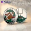 A football flipping coin displaying the words "heads kick off" on one side.