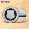 Two police challenge coins featuring badges with the words "Protect" and "Serve" prominently displayed on them.