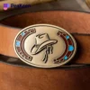 A stylish belt featuring a cowboy hat, adorned with Rodeo Brass Belt Buckles, perfect for a western-themed outfit.