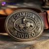 A brass belt buckle featuring the words "Champion Rodeo," showcasing a classic rodeo design.