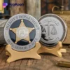 A sheriff's department challenge coin displayed on a wooden stand, showcasing its detailed design and craftsmanship.