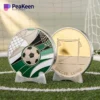 A soccer ball and a soccer-themed coin resting on a vibrant green soccer field.
