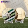 A soccer ball and a coin are placed on a table, showcasing a unique soccer-themed coin alongside the ball.