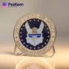 The US Air Force emblem showcased on a metal plaque, surrounded by squadron coins representing military excellence.