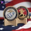 A collection of USMC challenge coins displayed together, showcasing their unique designs and military significance.