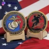 A collection of US Marine Corps challenge coins displayed together, showcasing their unique designs and insignia.