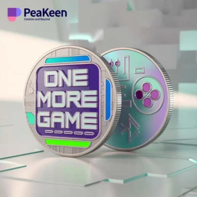 A video game challenge coin featuring the phrase "One More Game" prominently displayed on its surface.