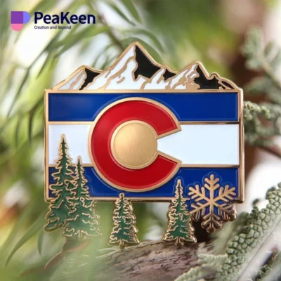 A pin showcasing the Colorado flag alongside trees, representing the state's scenic landscapes.