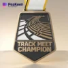 A medal featuring the words "Track Meet Champion," representing success in competitive track events.