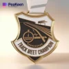 Medal featuring the inscription "Track Meet Champion," symbolizing athletic achievement in track events.