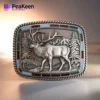 Elk belt buckle featuring a detailed design of a deer alongside a tree, showcasing nature-inspired craftsmanship.