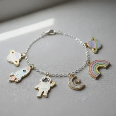 A colorful bracelet featuring an enamel space-themed charm and a vibrant rainbow design.