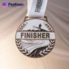 A finisher medal showcasing the word "Finisher," representing completion of a challenge.