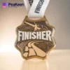 gold finisher medals featuring the word "Finisher" prominently displayed on its surface.