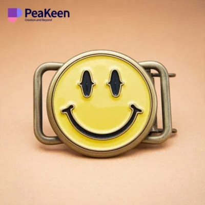 A cheerful smiley face belt buckle featuring a shiny metal finish, perfect for adding humor to any outfit.