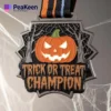 A shiny Halloween-themed medal featuring "Trick or Treat Champion" engraved on it, perfect for celebrating Halloween festivities.