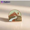 Enamel pin featuring the phrase "Hike More," perfect for hiking enthusiasts and collectors of hiking-themed accessories.