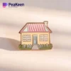 A decorative pin shaped like a house, representing warmth and belonging.