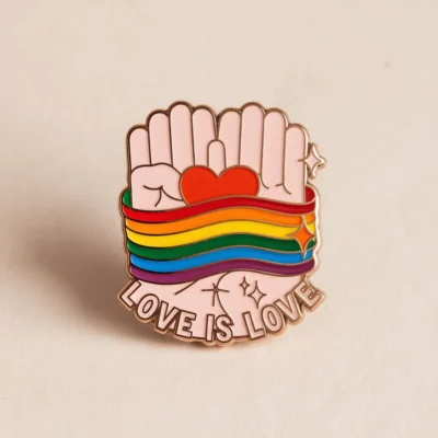 Enamel pin featuring the phrase "Love is Love," celebrating LGBT pride and inclusivity.