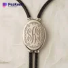 Silver monogrammed necklace with a leather cord, combining classic elegance with a contemporary bolo tie style.