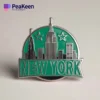 Stylish enamel pin depicting the New York City skyline, a perfect accessory for city lovers and pin collectors.