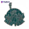 Enamel pin featuring the Statue of Liberty, a symbol of New York City, showcasing intricate details and vibrant colors.