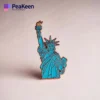 Detailed enamel pin of the Statue of Liberty, representing New York, with bright colors and fine craftsmanship.